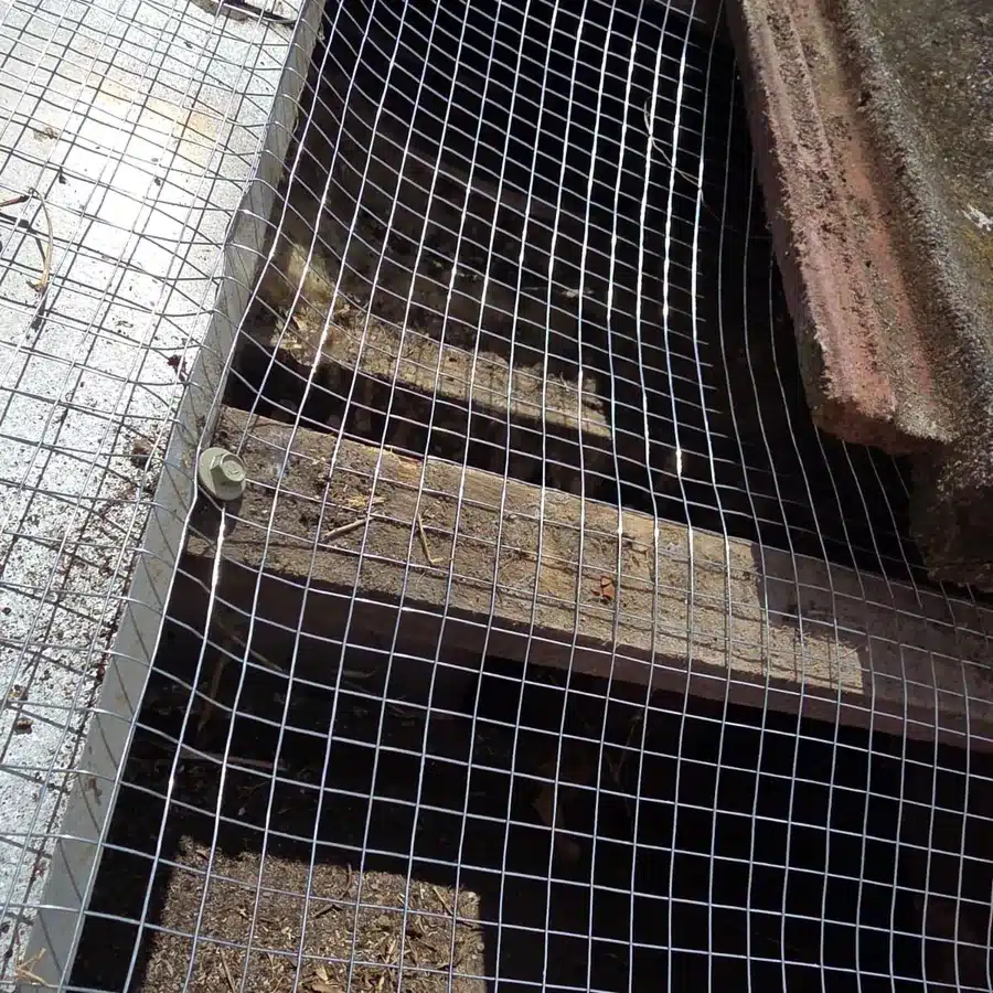 Galvanised mesh fixed across the roof battens under the tiles