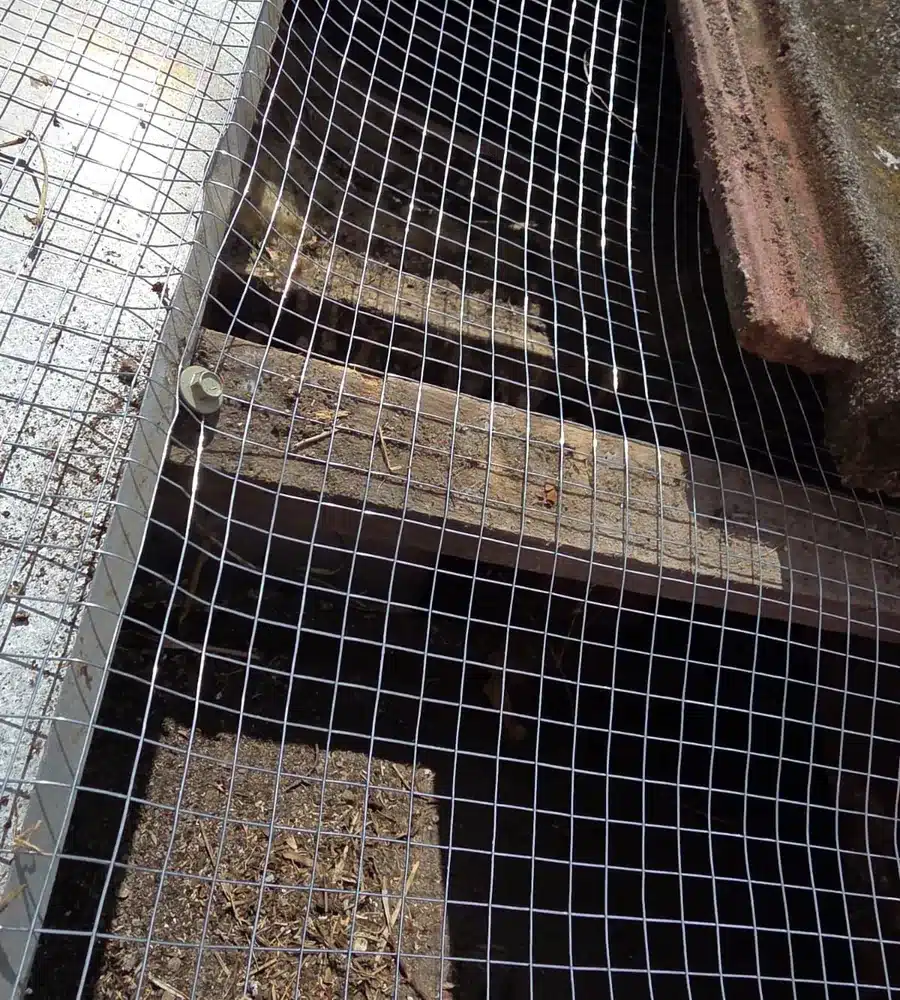 Galvanised mesh fitted under roof tiles to stop possums getting in